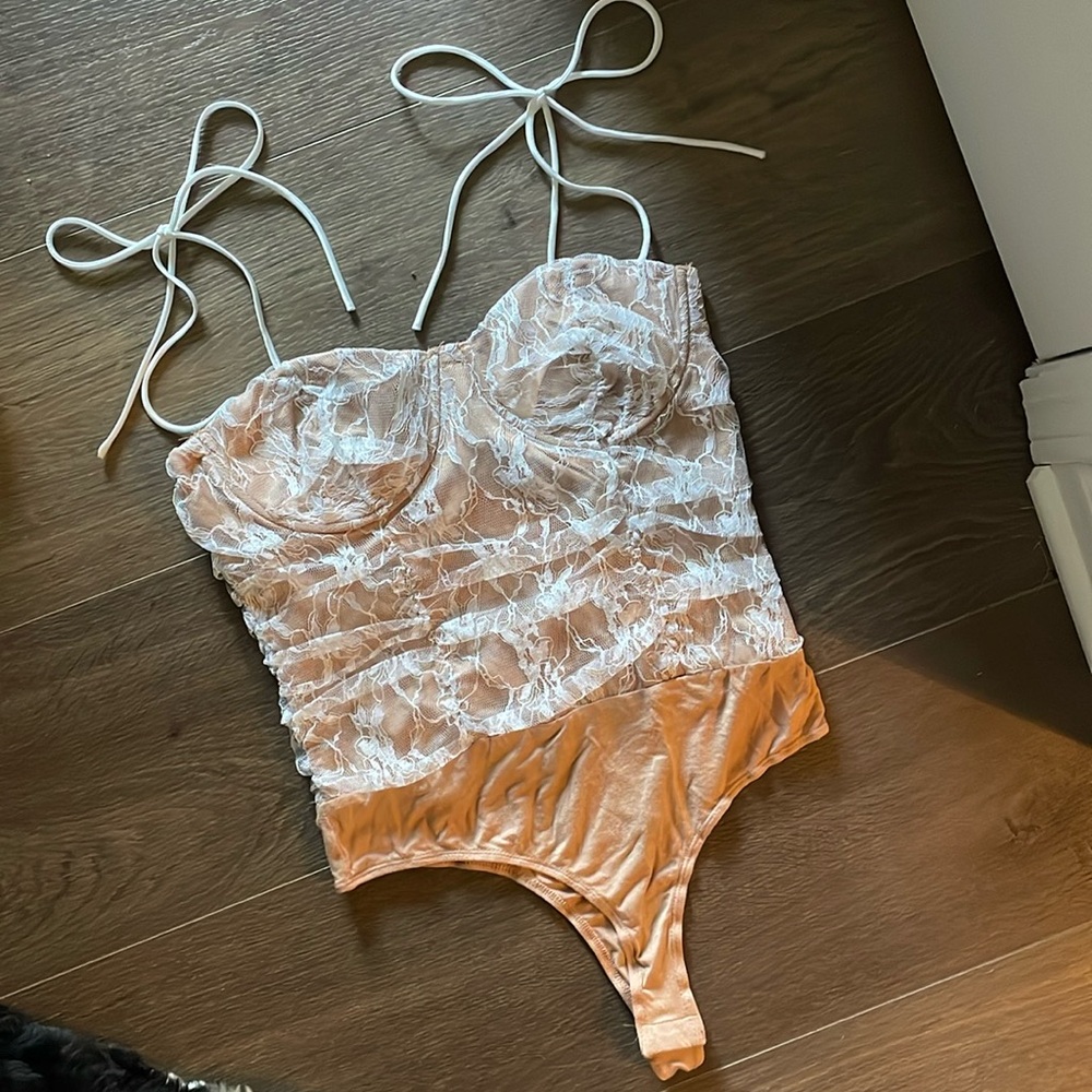 Corset bodysuit with tie straps.